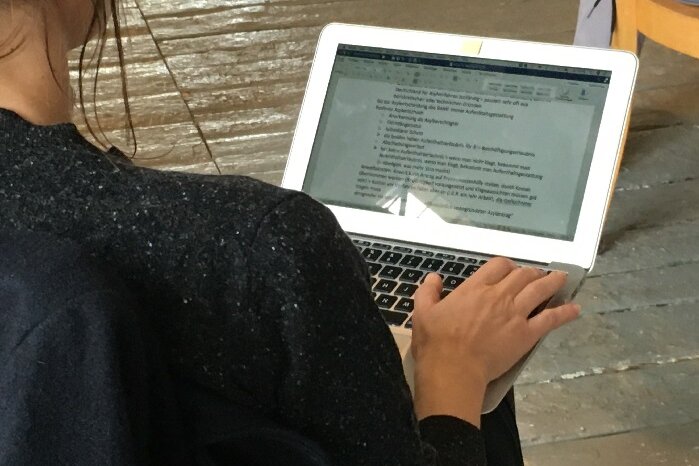 Frau arbeitet auf Macbook